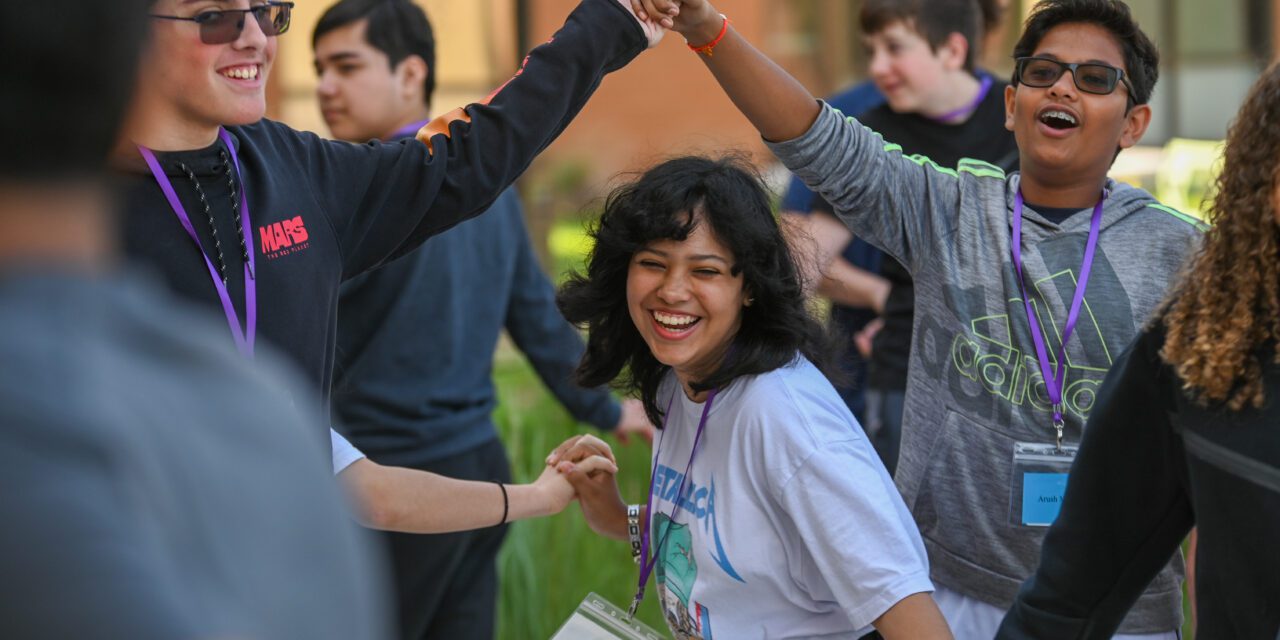 Student playing a team-building game